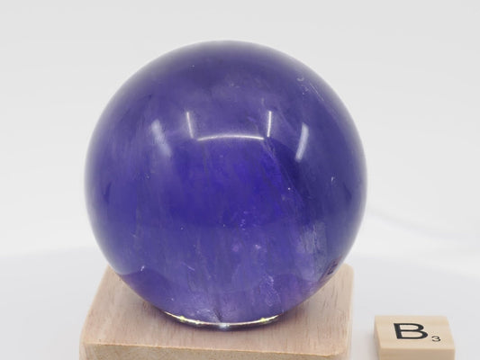 64mm royal purple Fluorite sphere specimen B showing dense color and velvet internal texture.