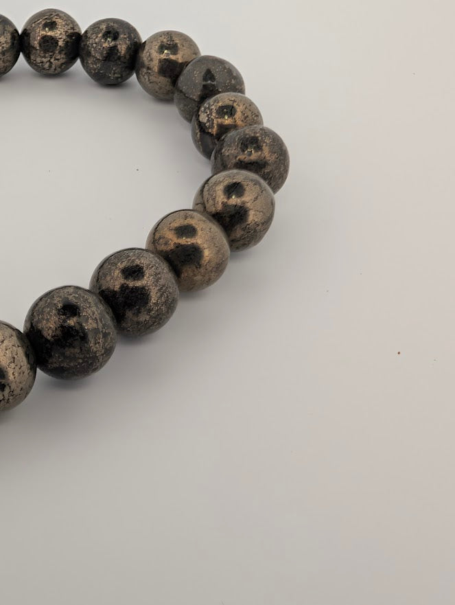 Angled detail of pyrite bracelet highlighting reflective surface and texture