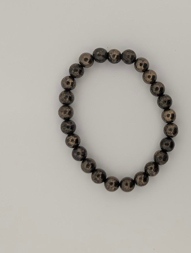 Top-down view of 8mm pyrite stretch bracelet on white background