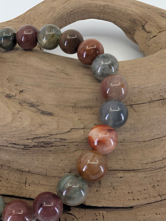6.5mm Rabbit Hair Rutile Quartz bracelet in 'Earthy Multi' showing red, orange, and smoky-grey rutile inclusions.