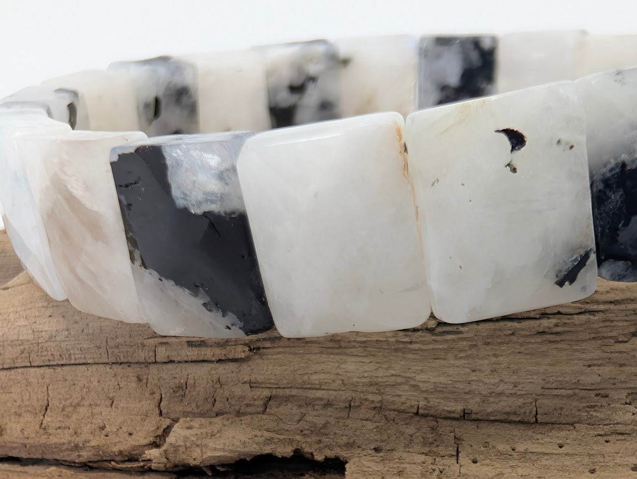 Detailed view of polished Rainbow Moonstone tiles with natural inclusions