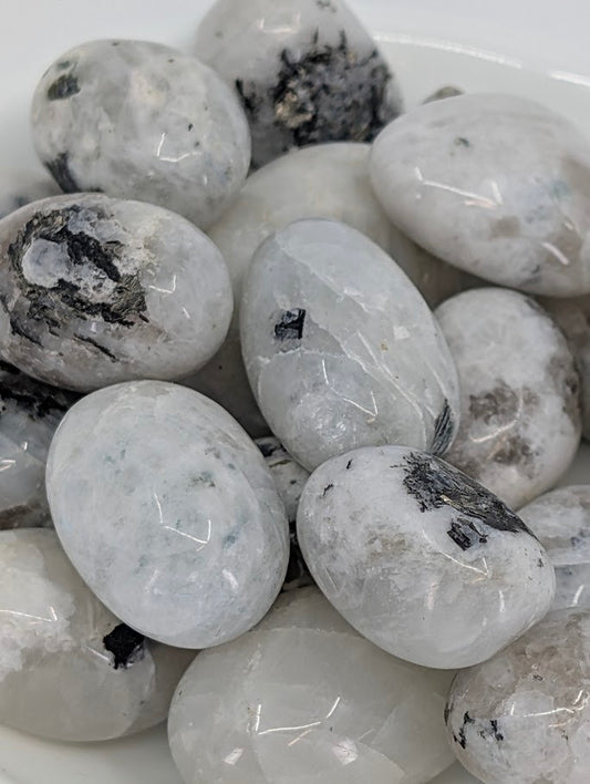 Close-up showing adularescence and tourmaline inclusions