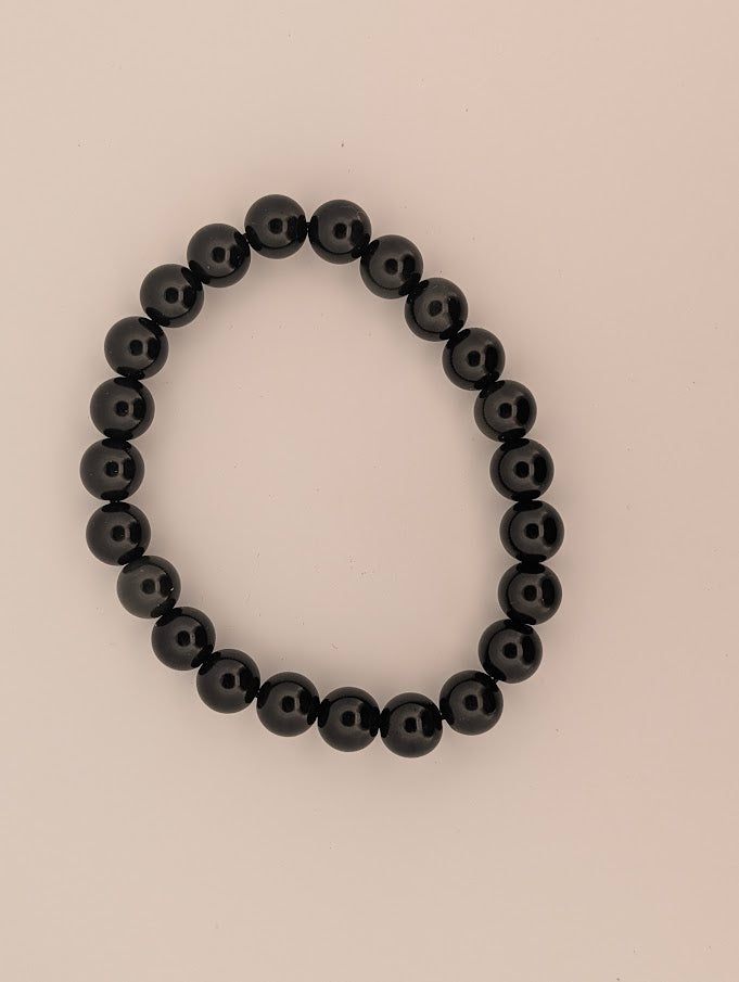 Top-down view of 8mm rainbow obsidian bracelet on white background