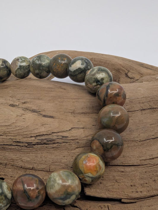 Closeup of rainforest jasper beads showing orbicular patterns and polished finish