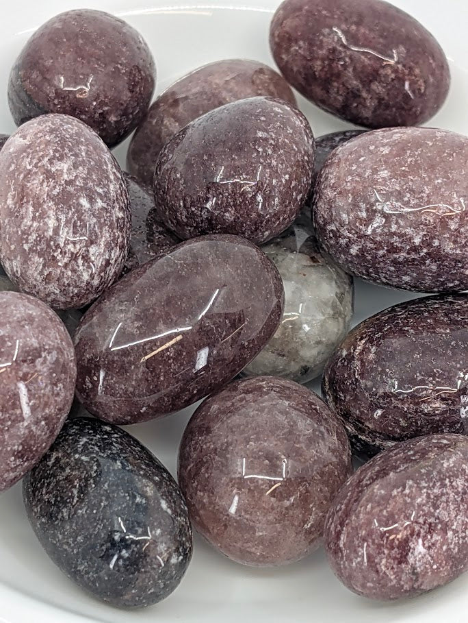 Close-up of Red Strawberry Quartz tumbled stones showing deep red color and sparkle