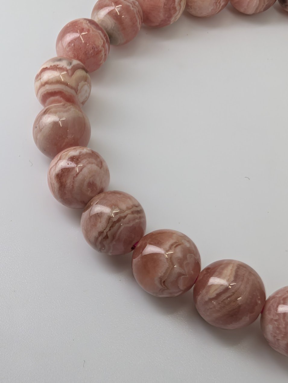 Detailed shot of rhodochrosite bead patterns and swirling bands