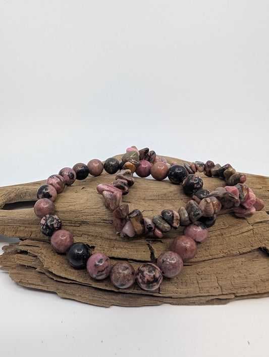 Rhodonite chip and 8mm round bracelets showing pink tones with black manganese veining on driftwood