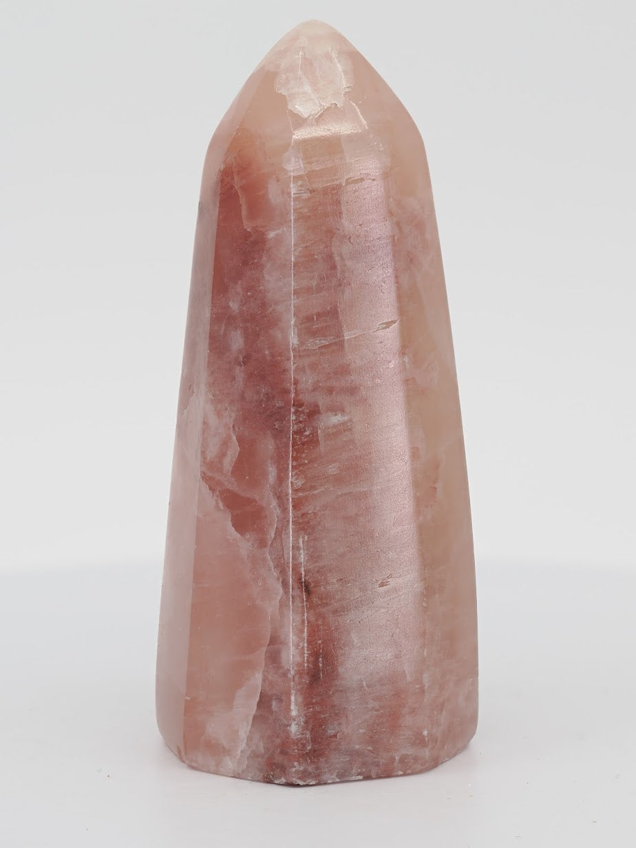 Polished Rose Calcite tower from Pakistan featuring soft pink manganoan coloration and a waxy luster.