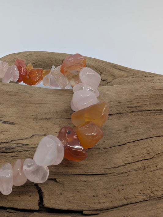 Close-up of Rose Quartz and Carnelian chips showing blush pink and warm orange tones