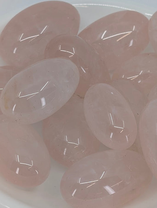 Close-up of Rose Quartz tumbled stones showing clarity and pink hue