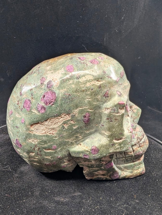 Ruby in Zoisite skull, left profile with ruby spots in green zoisite