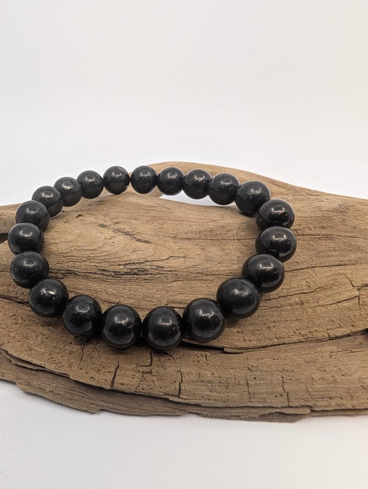 8MM Shungite bracelet displayed on wood background
