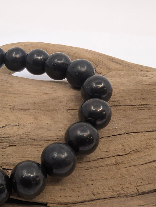 Close-up of polished 8MM Shungite bracelet beads