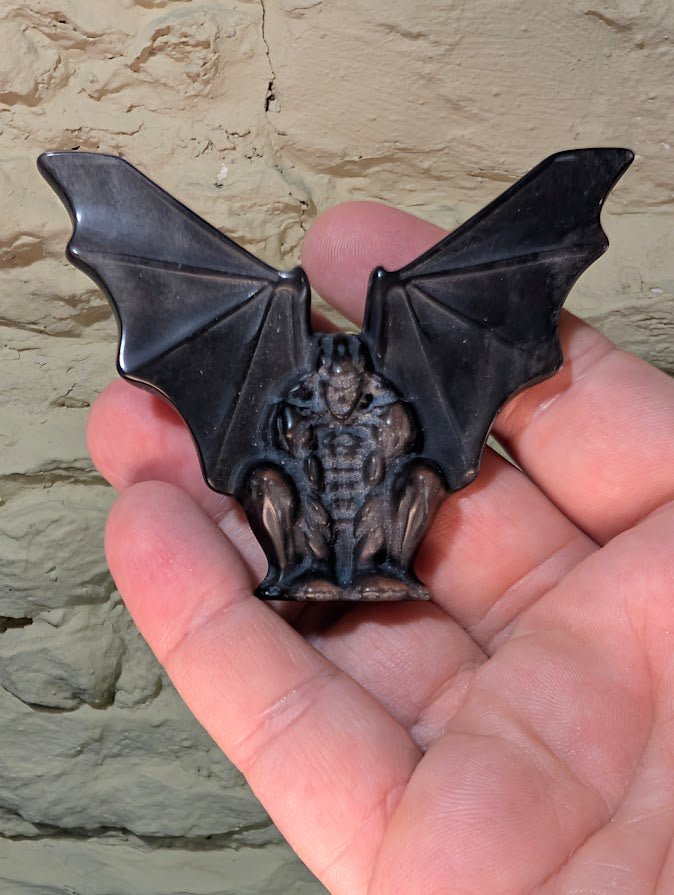 Silver obsidian gargoyle carving – front view in hand showing size and detail