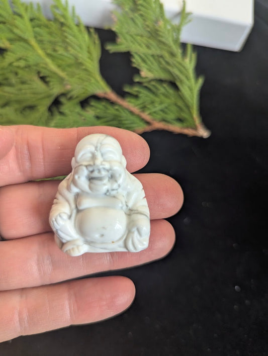 Front view of a 3.5cm Laughing Buddha carved from natural white Howlite.