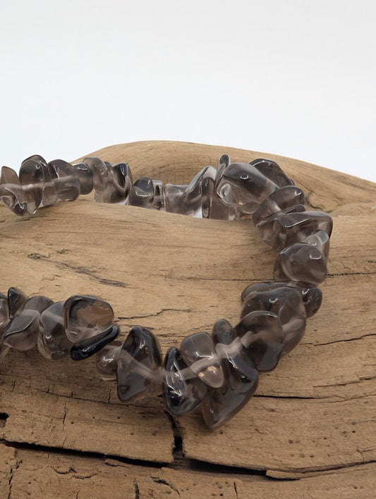 Closeup of smoky quartz chip bracelet showing polished, translucent grey chips
