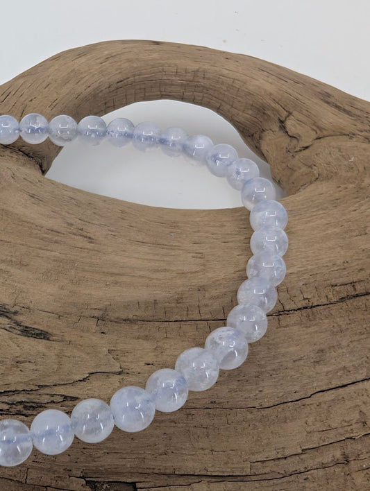 Close-up of Snowflake Blue Lace Agate beads with milky patterns