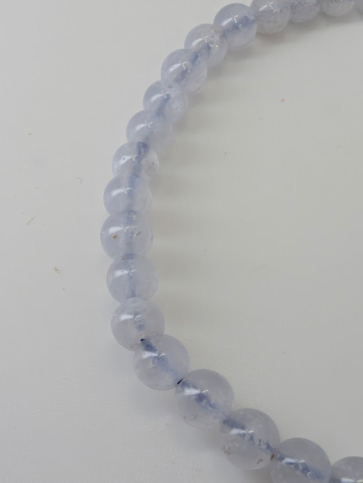 Detailed view of 4.5 mm Snowflake Blue Lace Agate beads showing natural pattern