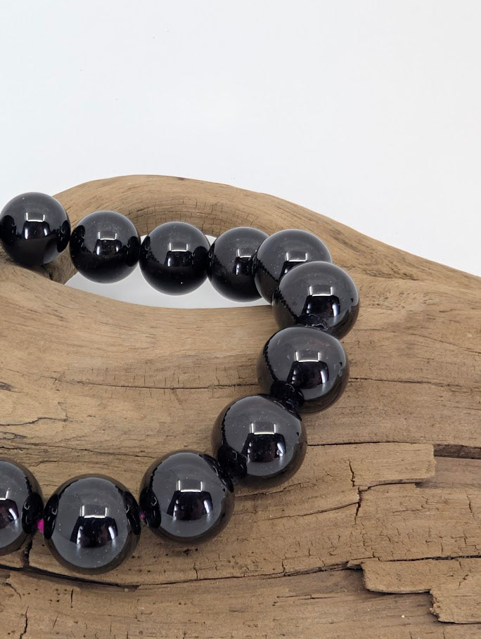 Close-up of star flash garnet bracelet showing reflective polish