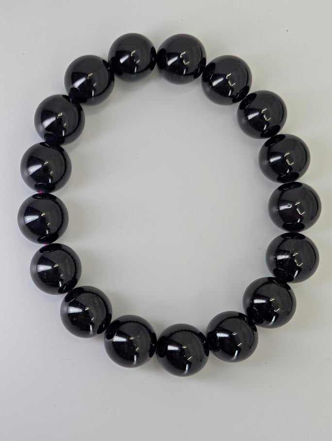 Overhead view of star flash garnet bracelet arranged in circle