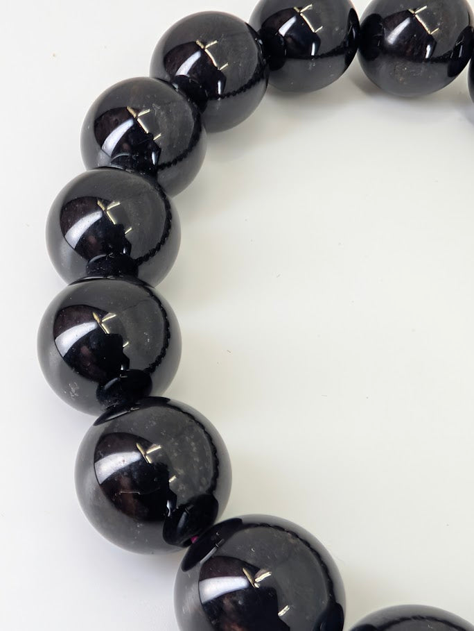 Detail photo showing subtle red inclusions and polish on garnet beads