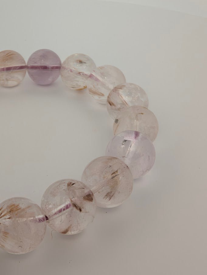 Close-up of 10MM Super Seven bracelet highlighting rutile and lepidocrocite inclusions