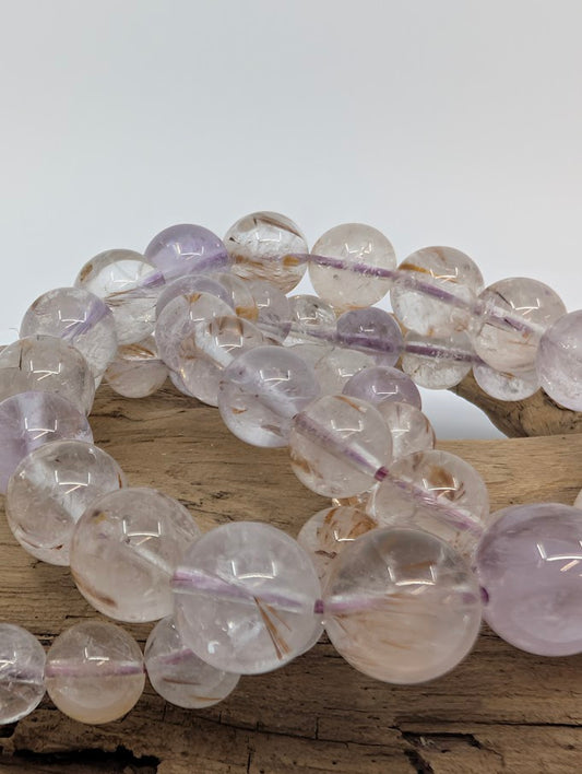 Close-up of Super Seven bracelet showing inclusions of rutile and amethyst