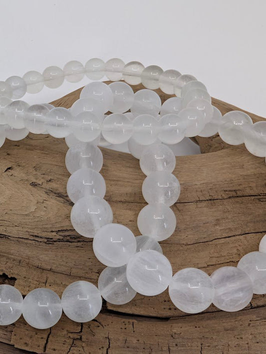Close-up of Velvet Fluorite beads with natural soft sheen and internal fiber-like pattern