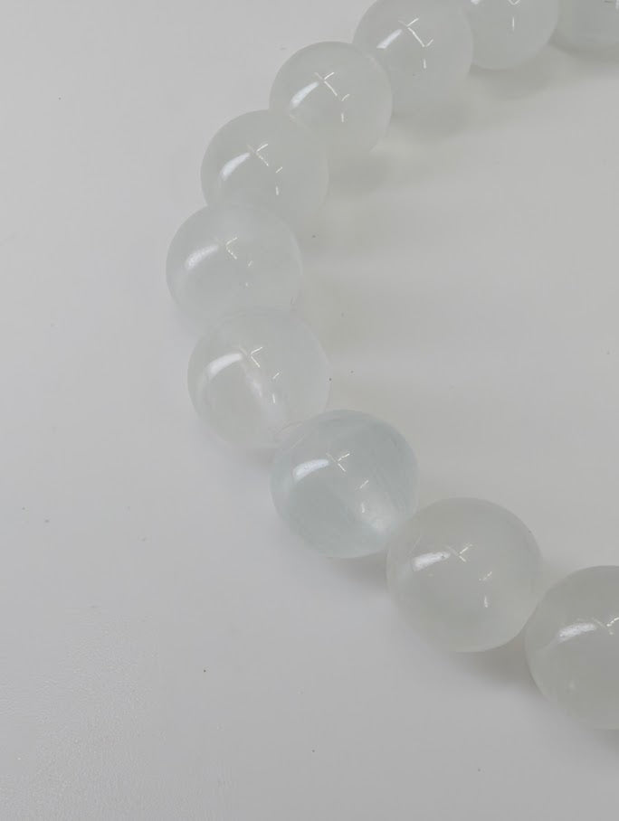Detailed view of Velvet Fluorite bracelet with reflective surface under white light