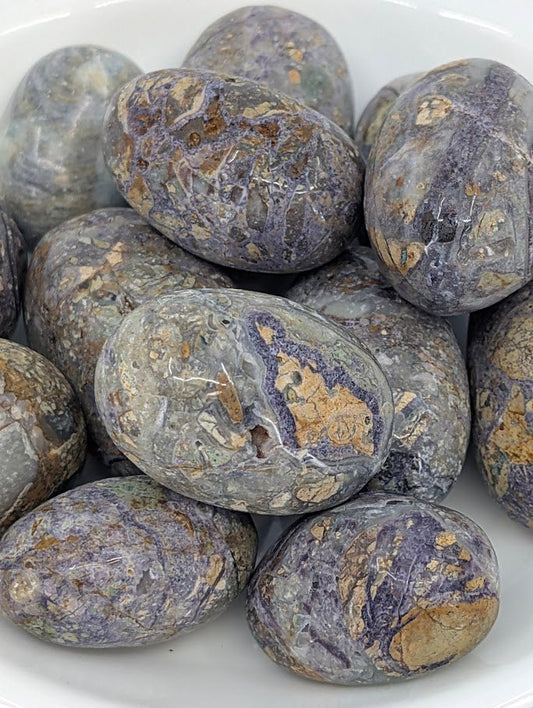 Close-up of Violet Jasper tumbled stones showing natural veining and color patterns