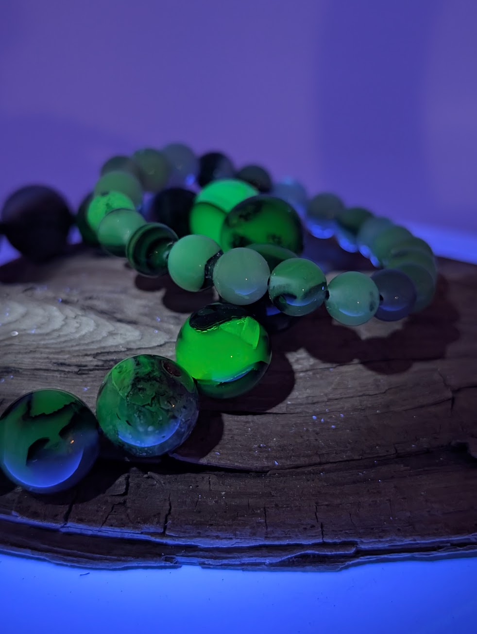 Volcano Agate bracelet glowing vivid green under UV light