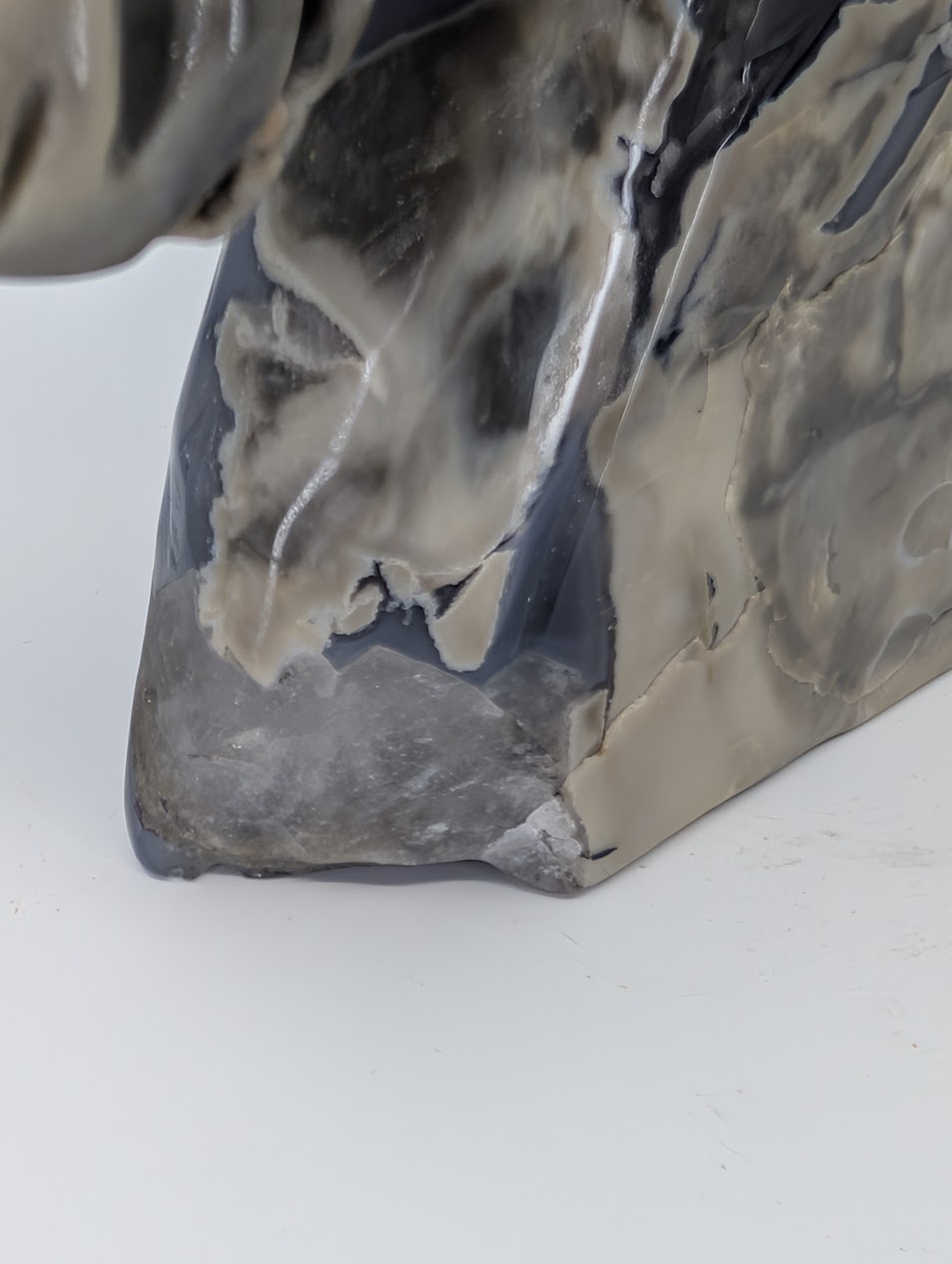 Front angle of polished volcano agate unicorn head sculpture with natural fracture