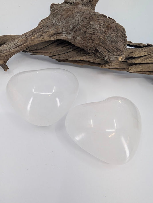 Pair of White Calcite hearts showing milky translucency and waxy luster.