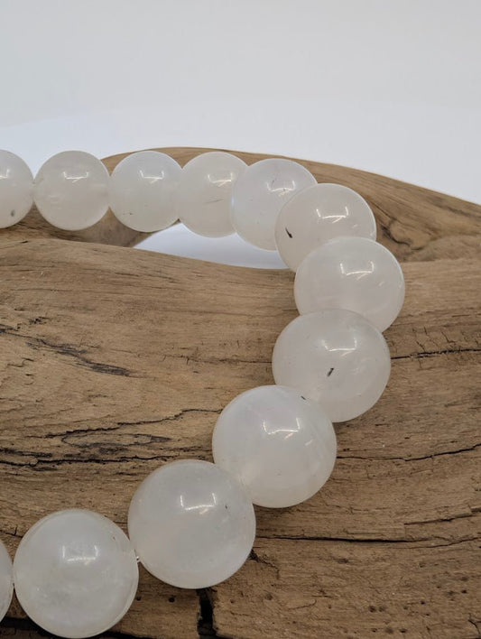 Close-up of polished 8MM White Moonstone beads with pearly shimmer