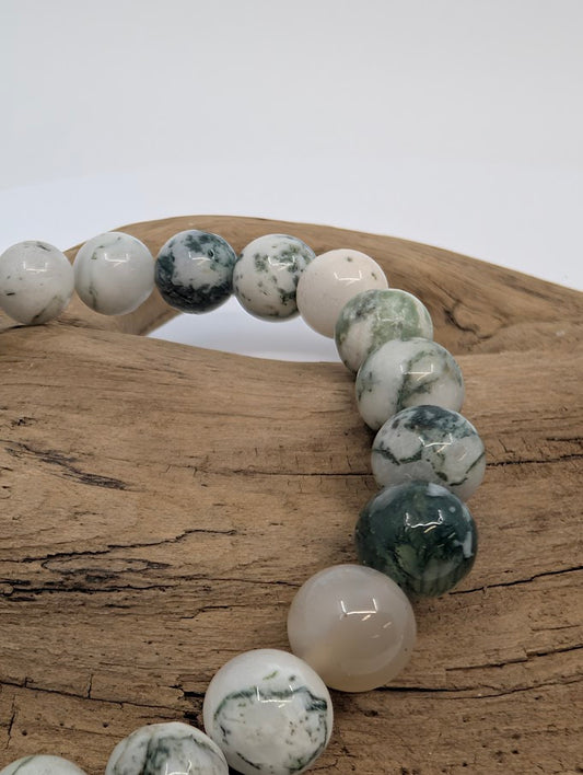 Close-up of 8MM White Moss Agate beads showing green dendritic patterns