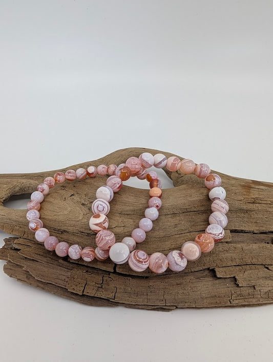 Yancheng banded agate bracelets in 6mm and 8mm showing soft pink and white banding