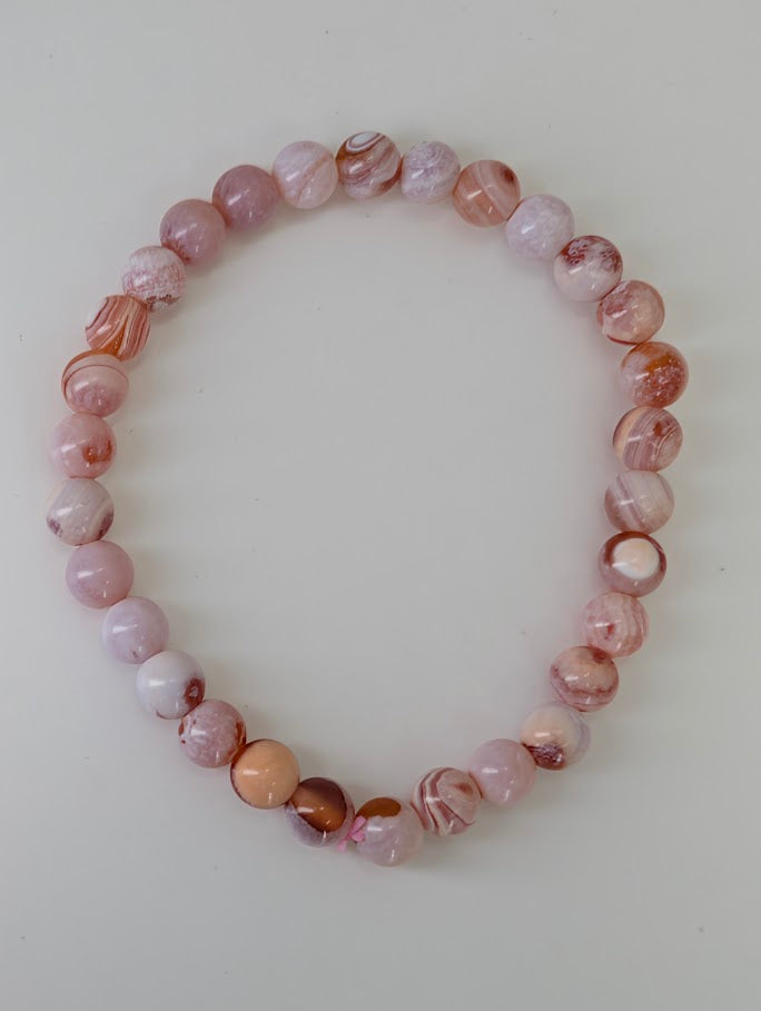 Top-down photo of 6MM Yancheng banded agate bracelet with smooth polish