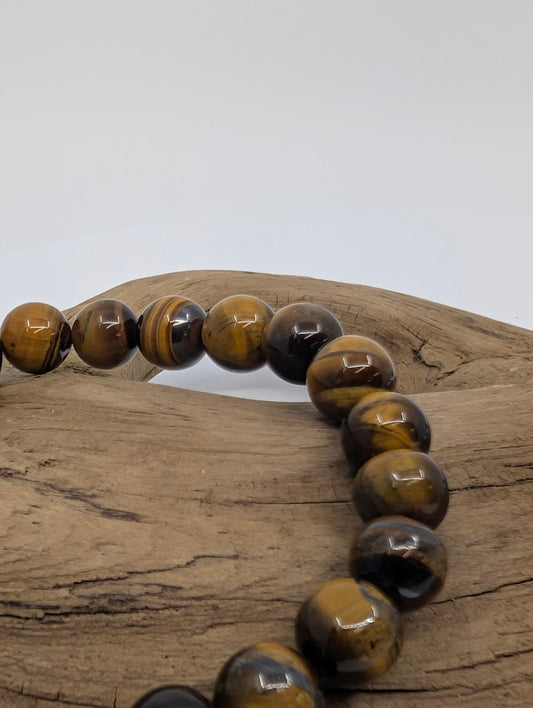 Close-up of polished 8MM Yellow Tiger Eye beads showing golden shimmer