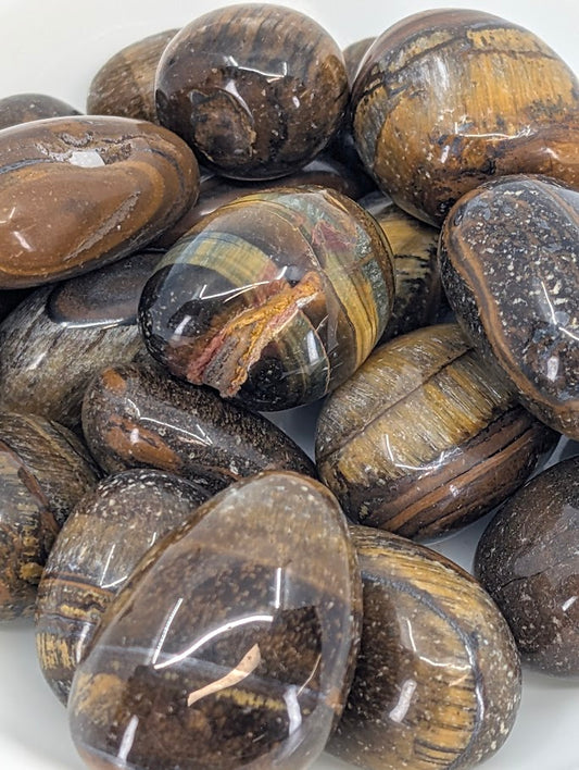 Close-up of polished Yellow Tiger Eye stones highlighting banding and chatoyancy