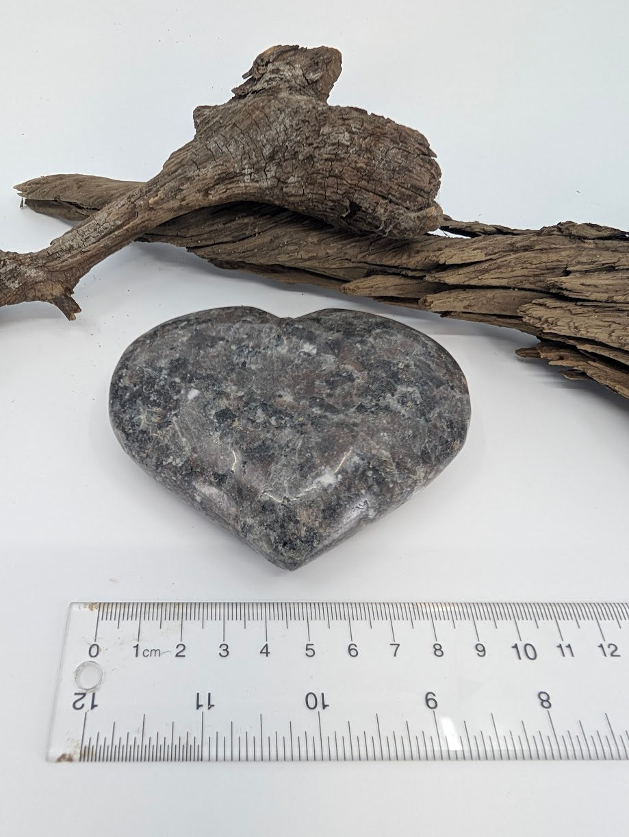 Angle view of large Yooperlite heart showing thickness and granite-like pattern.