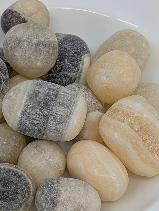 Close-up of Zebra Calcite tumbles showing banding detail