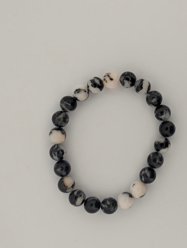 Overhead view of Zebra Jasper 8mm bracelet on white background