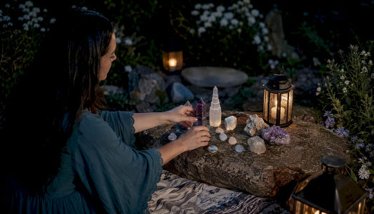 Woman arranging moon ritual crystals on altar