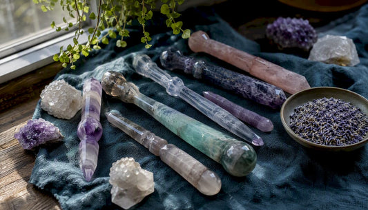Polished crystal wands on wooden table with smudge sticks