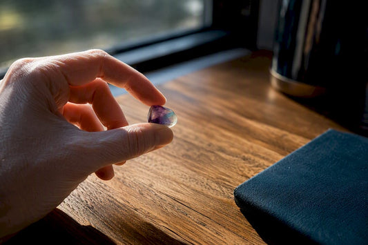 Hand holding a focus crystal before work