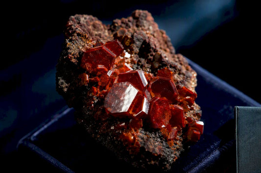 Red-orange vanadinite crystals on dark matrix
