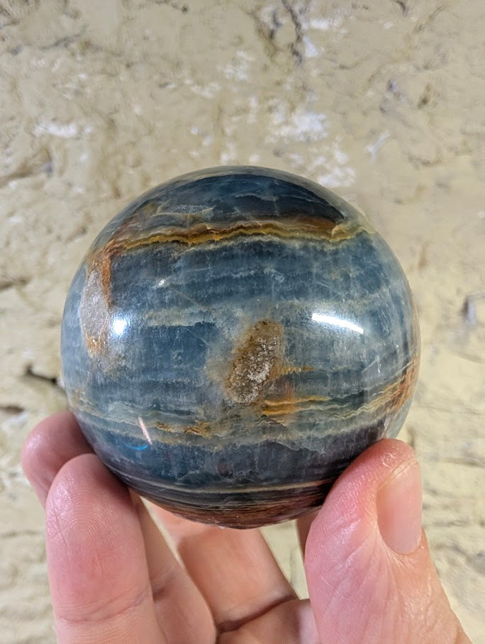 Angled view showing blue calcite layers and warm veining