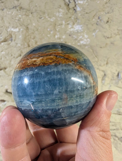 Cross-banding detail on natural blue onyx sphere from Argentina