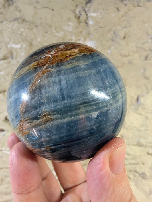 Front view of 67mm blue onyx sphere with golden banding