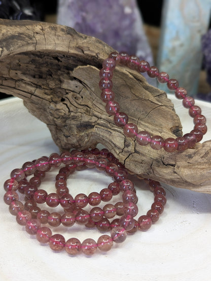 6mm Strawberry quartz bracelets on display